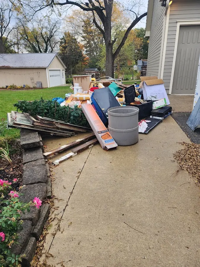 Dumpster being loaded with debris for 12 Yard Dumpster Rental in Miami Gardens